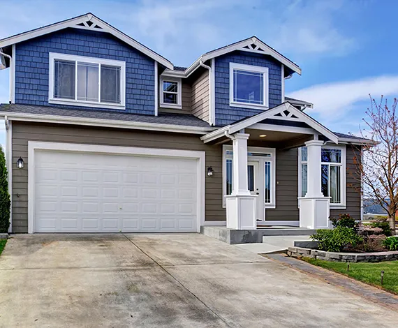 A modern suburban home with a two-car garage and a well-maintained driveway.